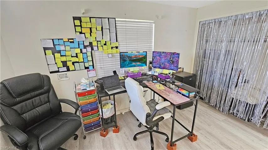 Office with light hardwood / wood-style floors