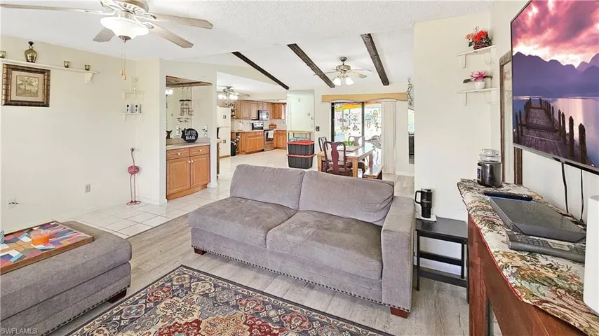 Living room featuring a textured ceiling and light hardwood / wood-style flooring