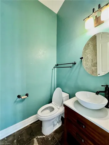 Half bathroom featuring toilet and vanity