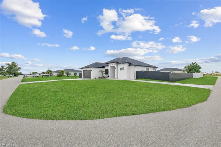 Prairie-style house featuring a front lawn and a garage