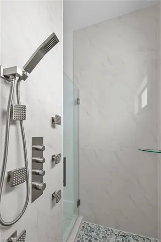 Bathroom featuring a tile shower