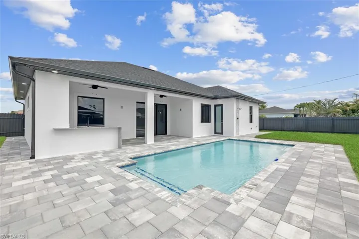 View of swimming pool featuring ceiling fan and a patio