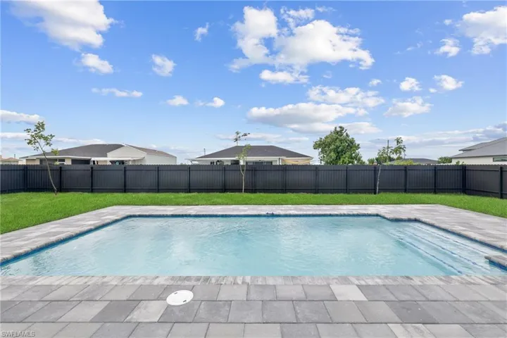 View of pool featuring a yard