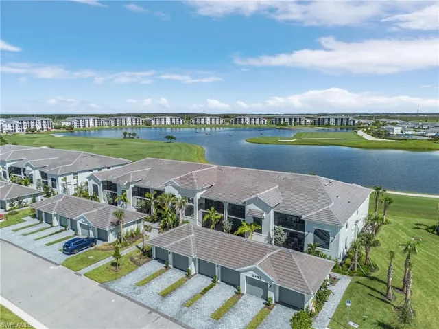 Drone / aerial view with a water & golf course view