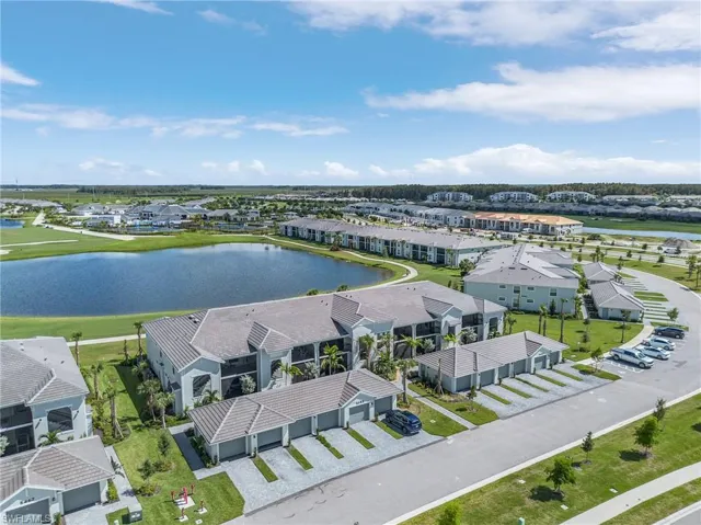 Drone / aerial view with a water & golf course view