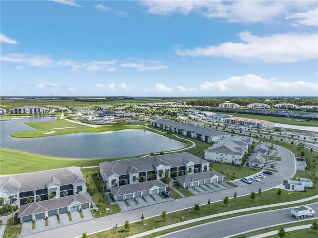 Drone / aerial view with a water & golf course view