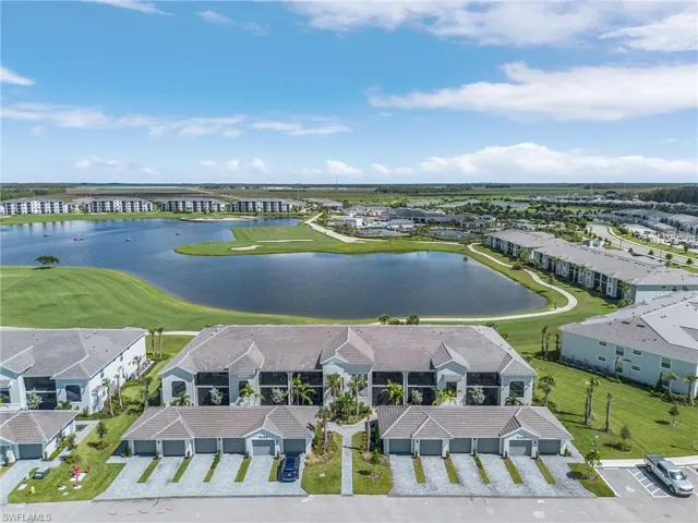Birds eye view of property with a water & golf course view