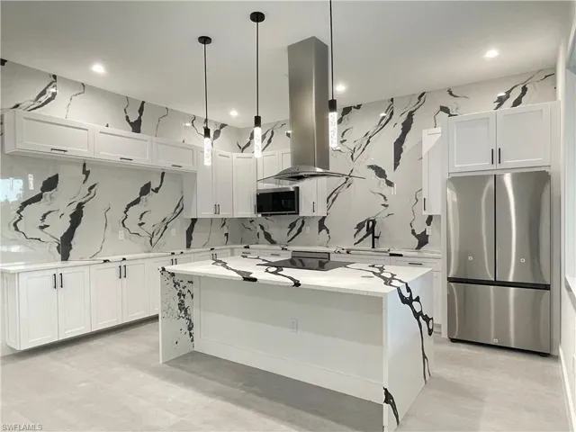 Kitchen with a center island, stainless steel appliances, white cabinetry, island exhaust hood, and pendant lighting