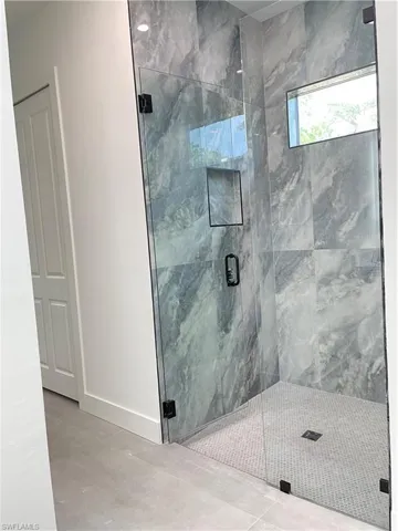 Bathroom with a shower with door
