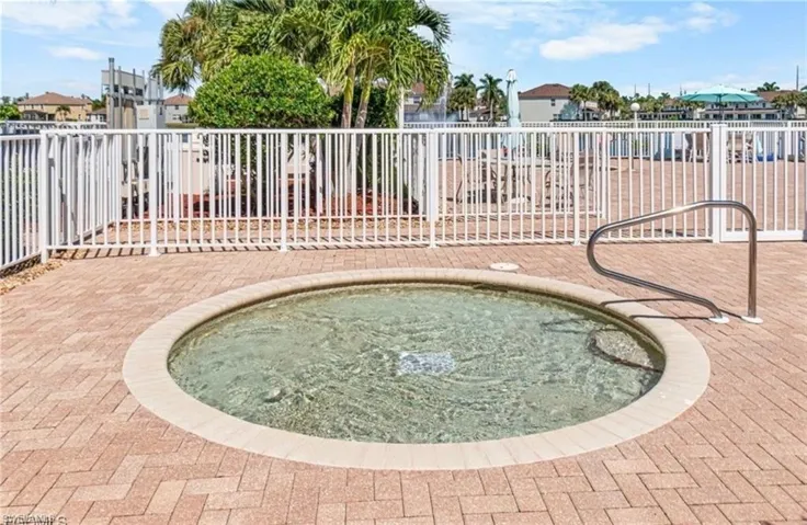 View of swimming pool with a hot tub and a residential view