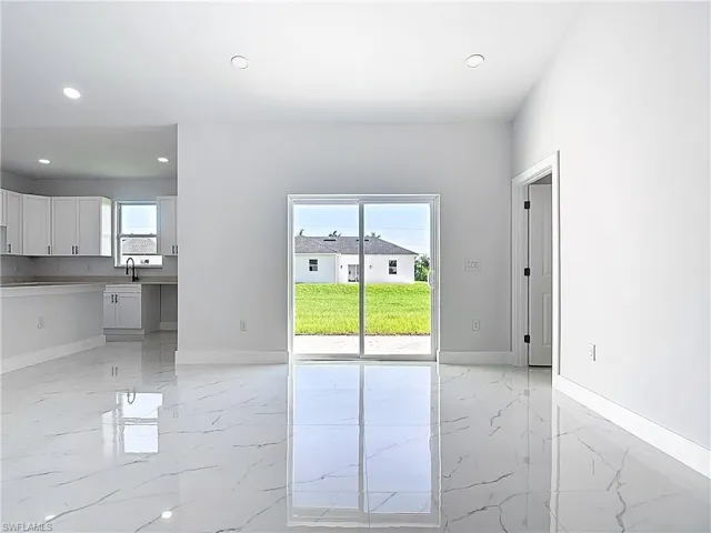 Spare room featuring light marble finish floors and recessed lighting