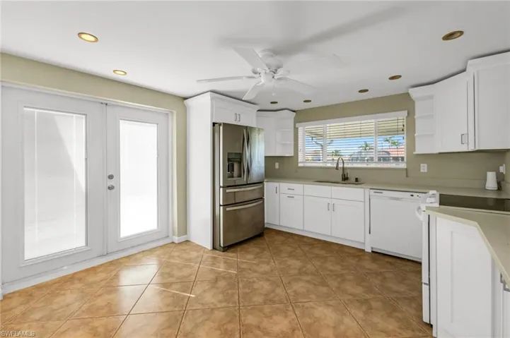 Kitchen featuring open shelves, white appliances, white cabinets, light tile patterned floors, and recessed lighting