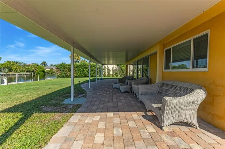 View of patio featuring a water view and an outdoor living space