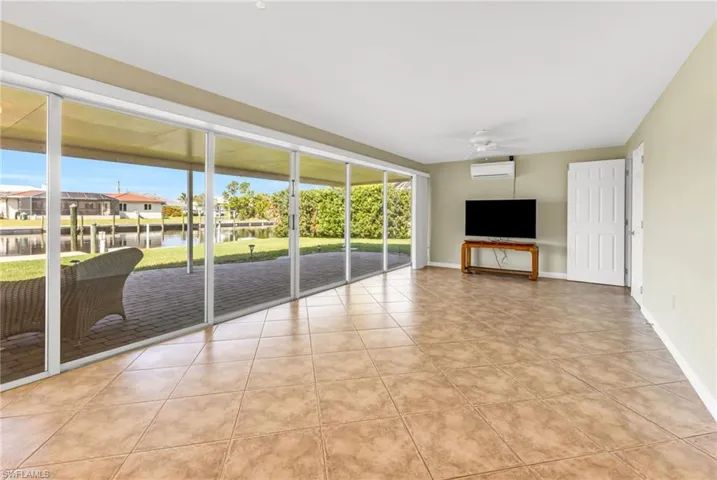 Unfurnished living room with light tile patterned floors, plenty of natural light, and ceiling fan