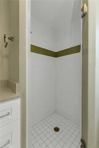 Bathroom with a shower stall and vanity