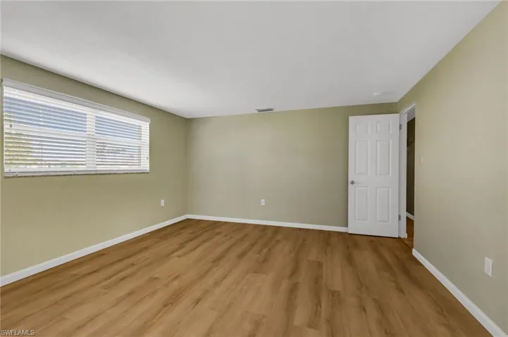 Unfurnished room with baseboards and light wood-style floors
