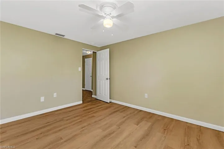 Spare room with light wood-type flooring and a ceiling fan