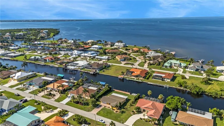 Aerial perspective of suburban area featuring a large body of water