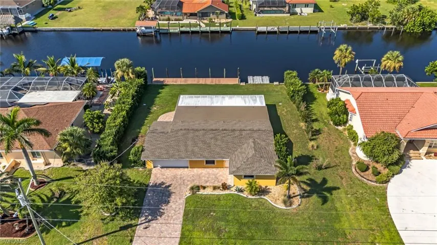 Aerial perspective of suburban area featuring a nearby body of water