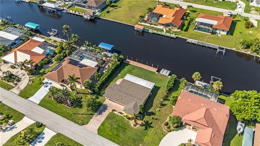 Aerial view of residential area featuring a nearby body of water