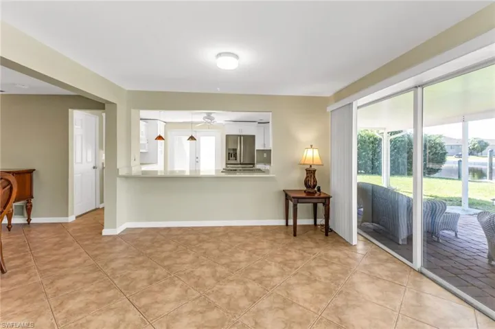 Living room featuring light tile patterned floors and a ceiling fan