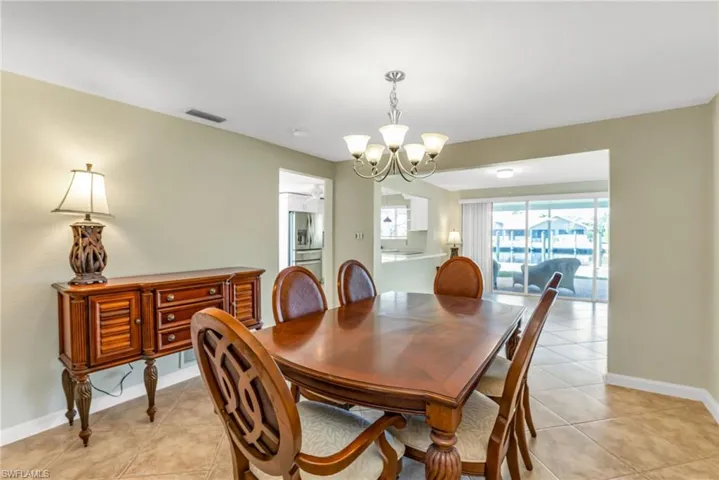 Dining space featuring a chandelier and light tile patterned flooring