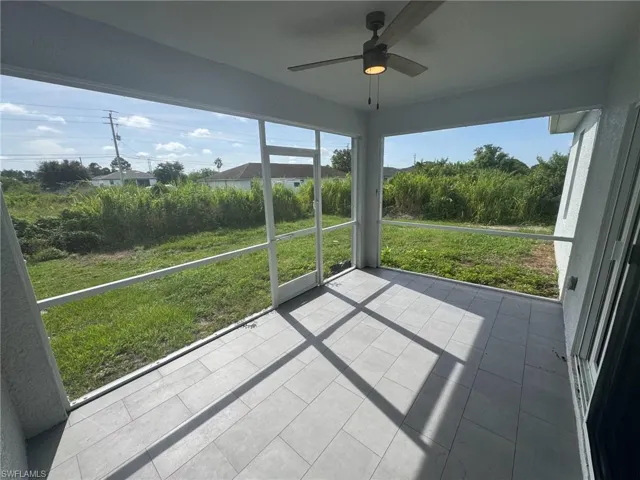 Unfurnished sunroom with ceiling fan
