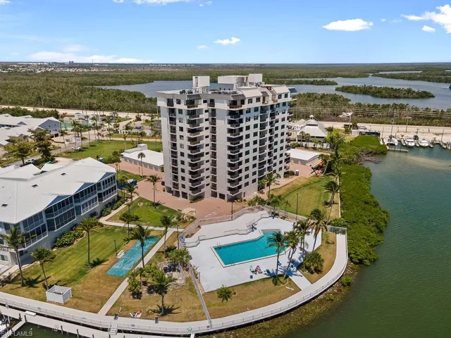 Birds eye view of property with a water view