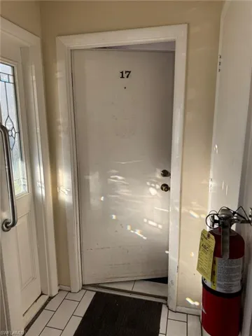 Doorway with a wealth of natural light and light tile patterned floors