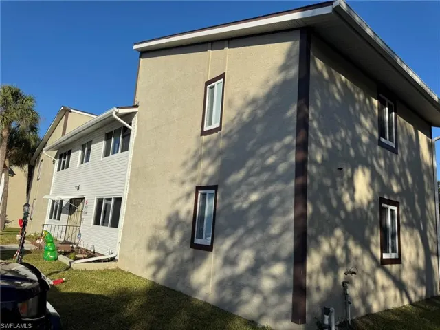 Rear view of house with a yard