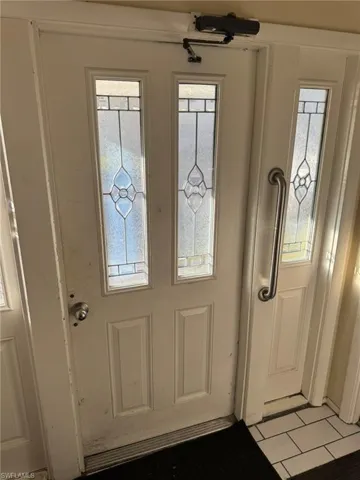 Doorway to outside with light tile patterned floors and a wealth of natural light