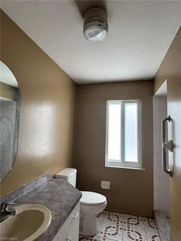 Bathroom with tile patterned floors, vanity, and toilet