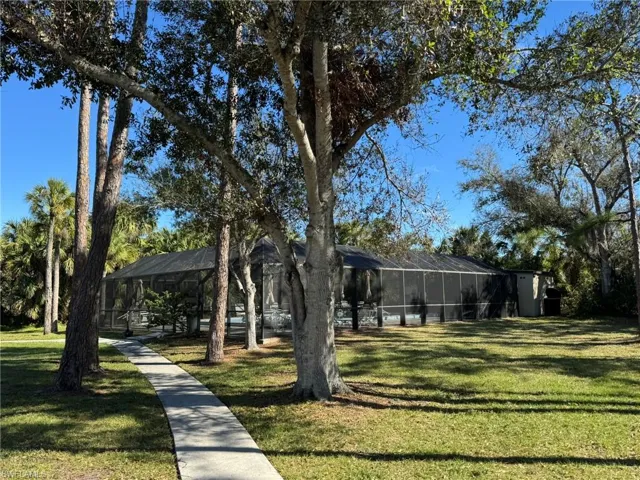 View of yard featuring glass enclosure