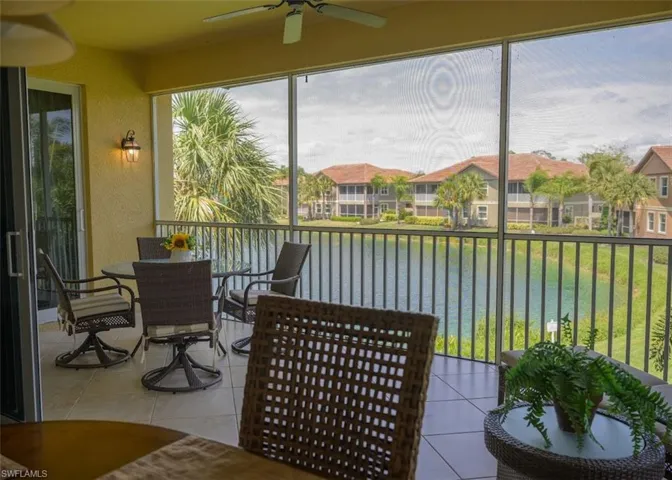 Sunroom with a water view and ceiling fan