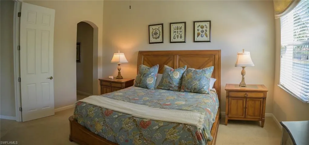 Bedroom with light colored carpet
