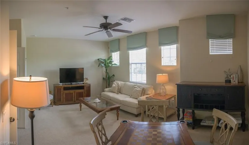 Living room featuring ceiling fan and light colored carpet