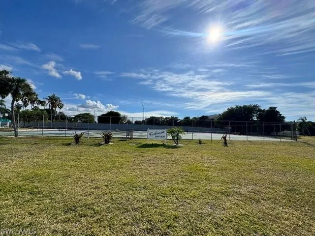 View of yard featuring a tennis court