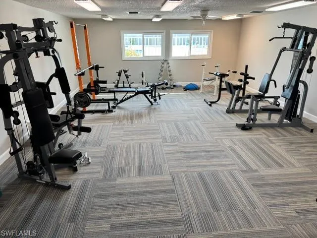 Workout area featuring a textured ceiling
