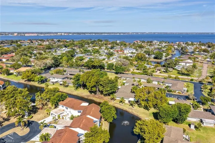 Aerial perspective of suburban area featuring a large body of water