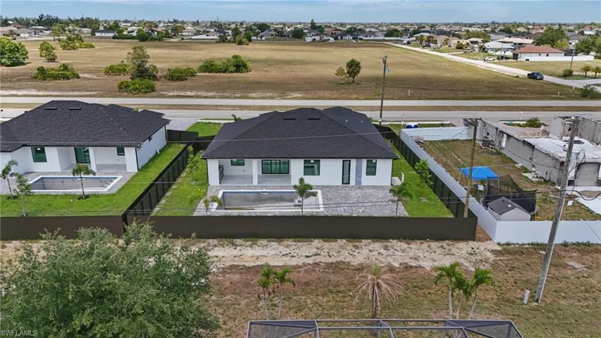 Rear view of house with a fenced backyard, a patio area, and a residential view