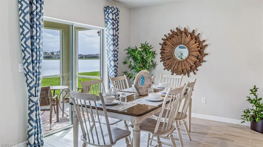 Dining area featuring a water view and light hardwood / wood-style flooring