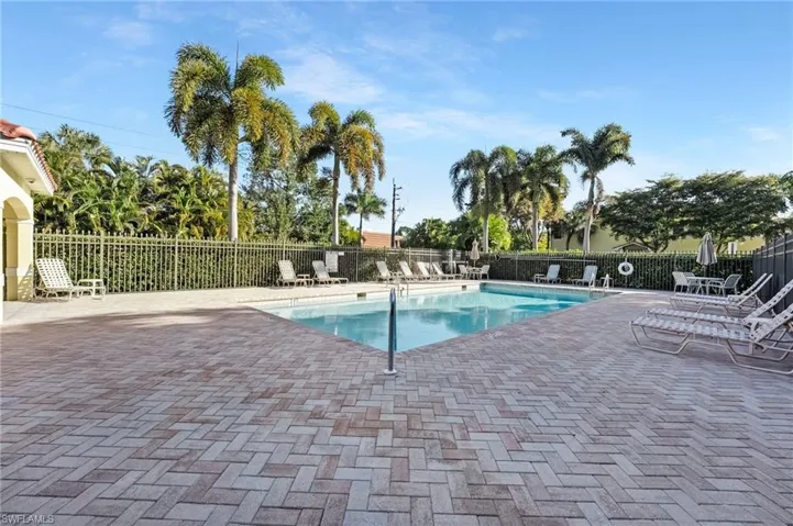Community pool with a patio