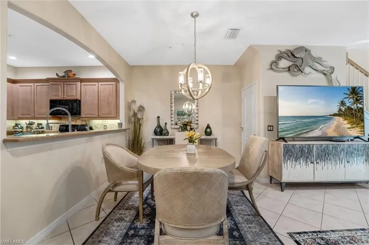 Dining room featuring light tile patterned floors and a chandelier