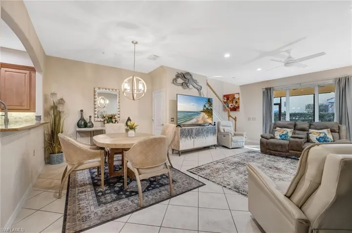 Dining room featuring light tile patterned flooring, ceiling fan, and suspended lighting