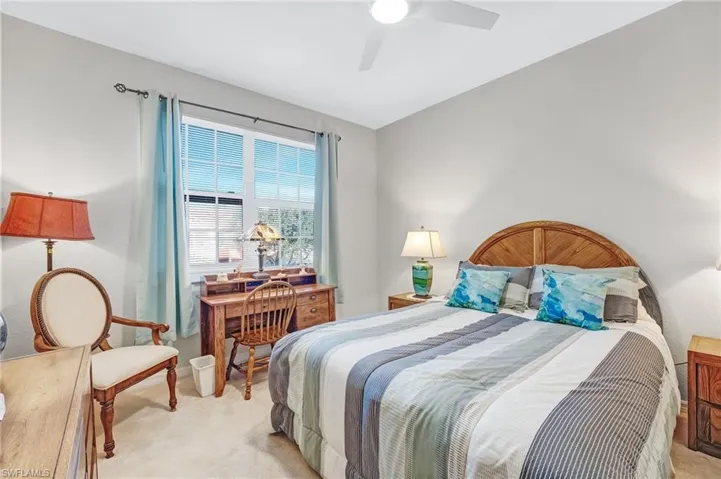 Bedroom featuring light colored carpet and ceiling fan