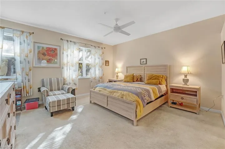 Bedroom featuring light carpet and a ceiling fan