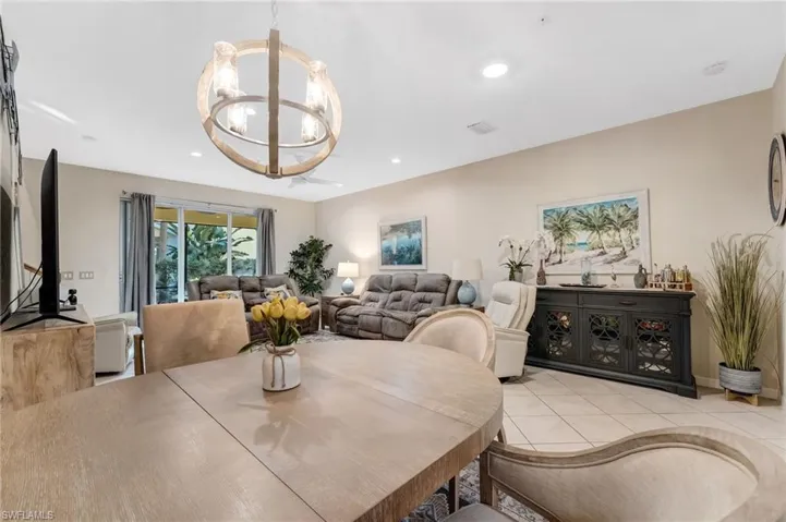 Tiled dining area featuring hanging lights