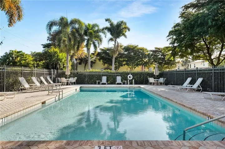 Community pool with a patio
