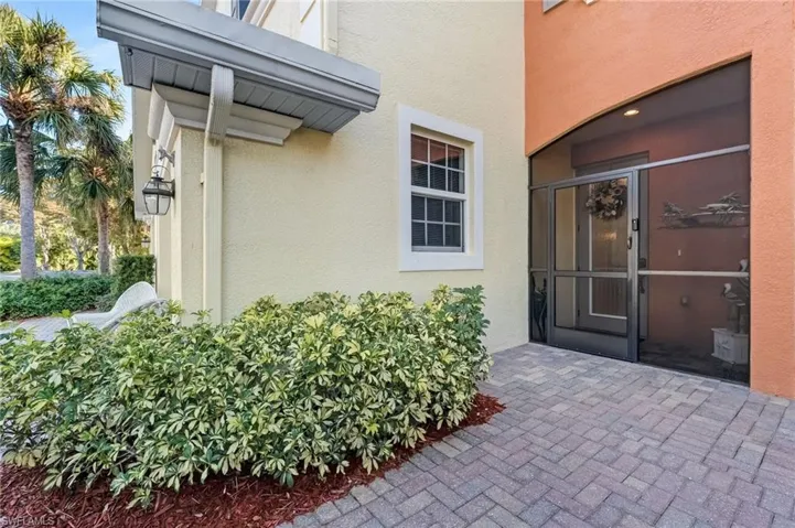 Doorway to property featuring stucco siding