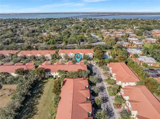 Aerial view of residential area featuring a nearby body of water and a notable bridge